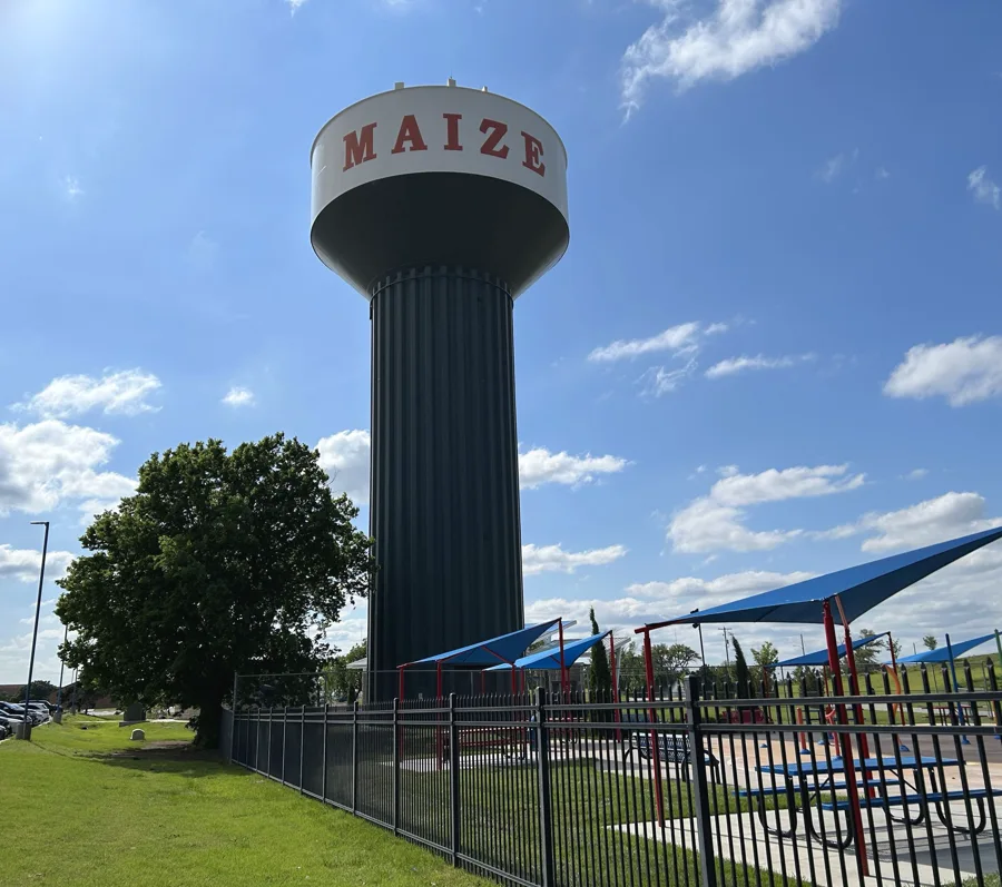 Maize water tower beside shaded outdoor recreation space